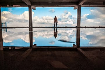 a man standing in front of a large window